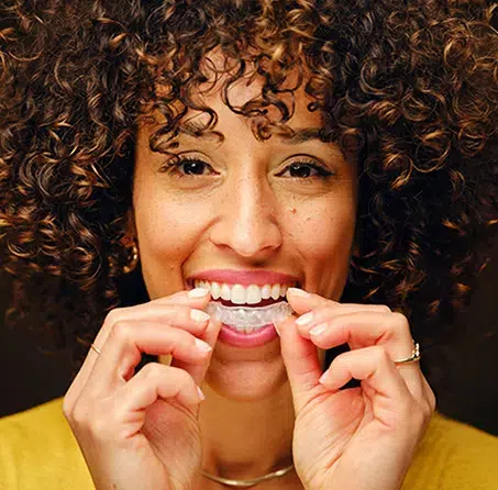 Confident smile of a woman wearing Invisalign in Cary NC