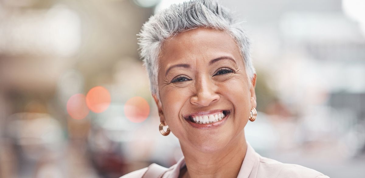 Senior woman smiling with healthy teeth after dental implant surgery