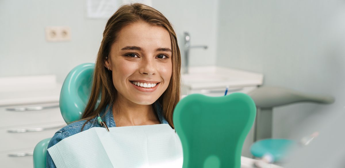 Confident woman checking results after professional teeth whitening