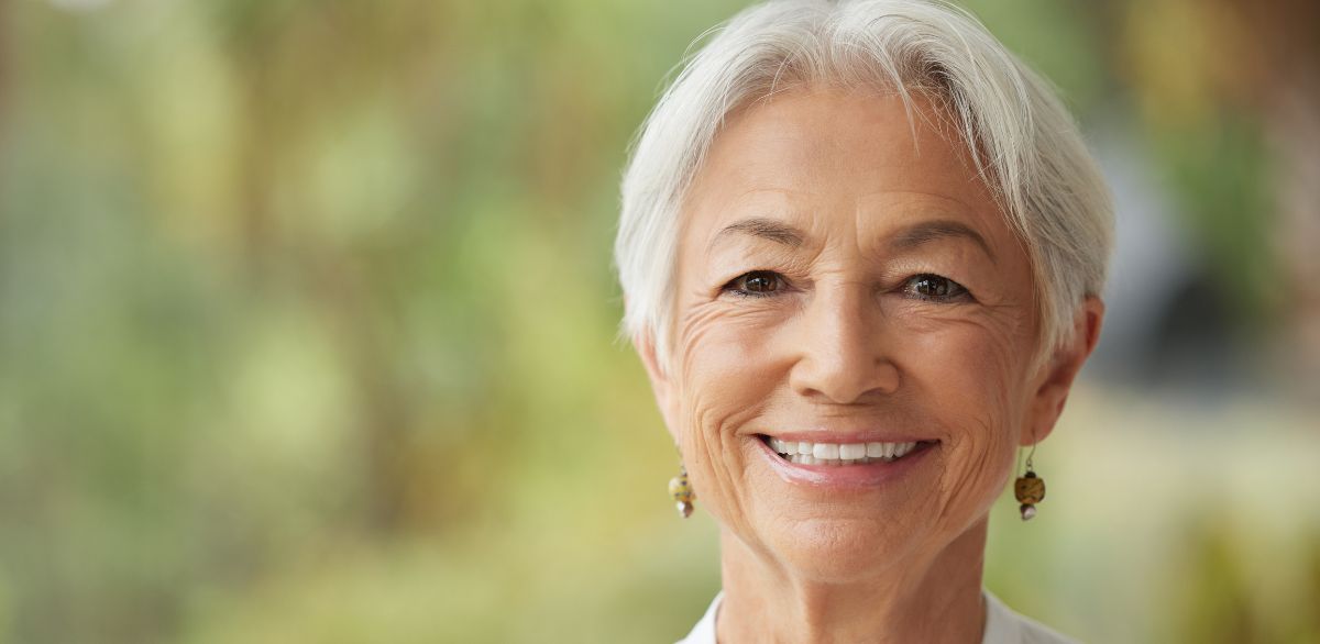Woman smiling with dental implant lasting result